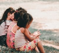 three little girls sitting in a row